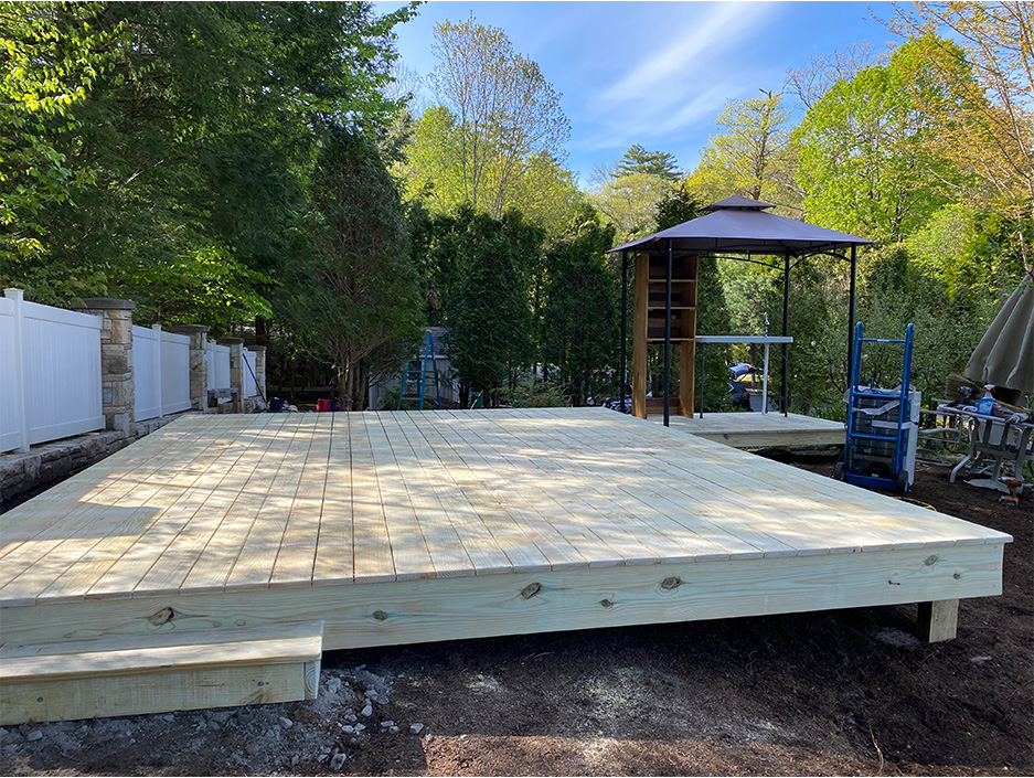 Pressure Treated Glam Camping Deck with Mini Bar Platform by Savvy Custom Builders